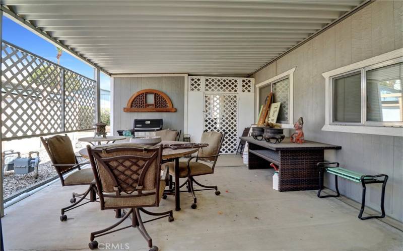 Outdoor patio under carport near parking area