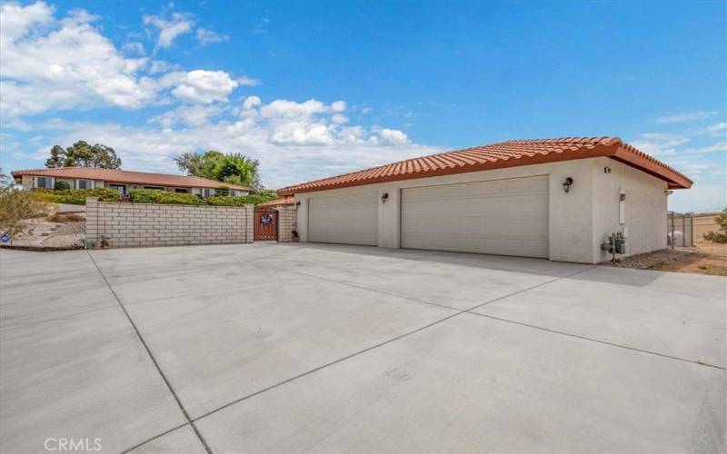 Home #2 - Four car finished garage and tons of hardscape for even more parking! Pool area has block wall for complete privacy from the street.