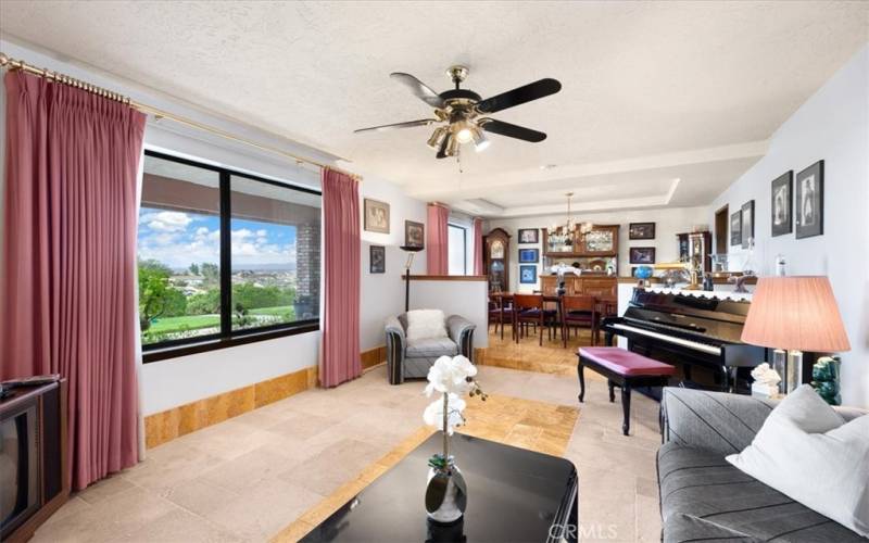 Primary Home - Living Room with Travertine Flooring and Large Window to take in the Views.