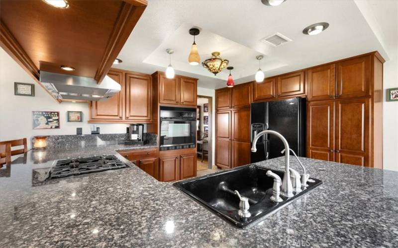 Primary Home - Kitchen with Features Beautiful Cherry Wood Cabinetry and Granite Countertops