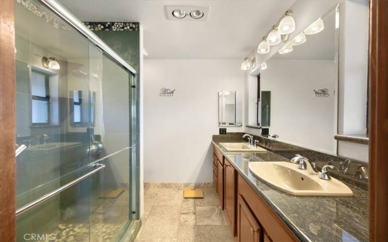 Primary Home - Primary Bathroom with Dual Sinks, Heat Lamps and Walk-in Shower with Slate Stone Slabs and Pebble Stone Flooring.