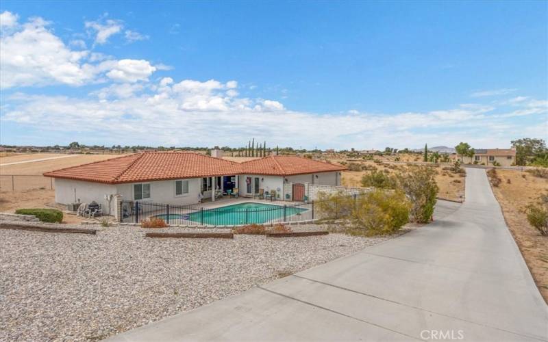 Home #2 - View from upper drive of Driveway. Pool area is fully fenced