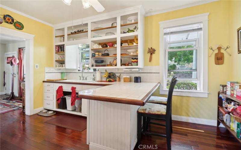 Kitchen with tiled counters and eat in bar