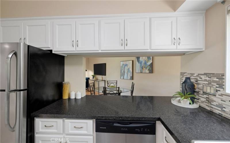 Updated kitchen with stainless steel appliances and pass through to dining area.