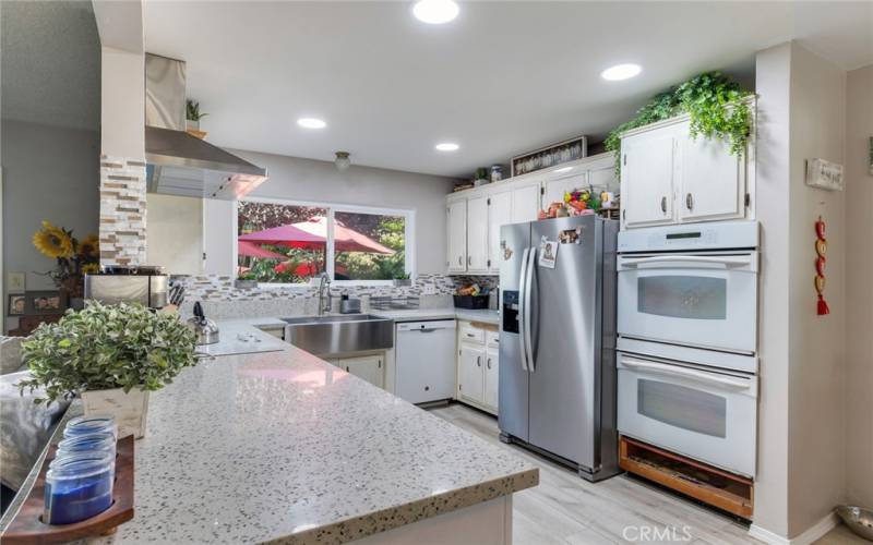 Kitchen with Farm Sink, Cooktop, Vented Hood, Double Ovens, Dishwasher