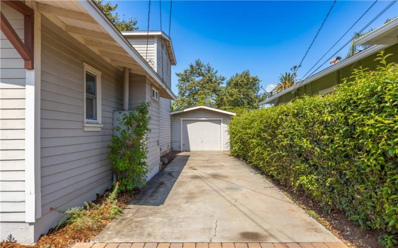 Driveway leading to a one car garage.