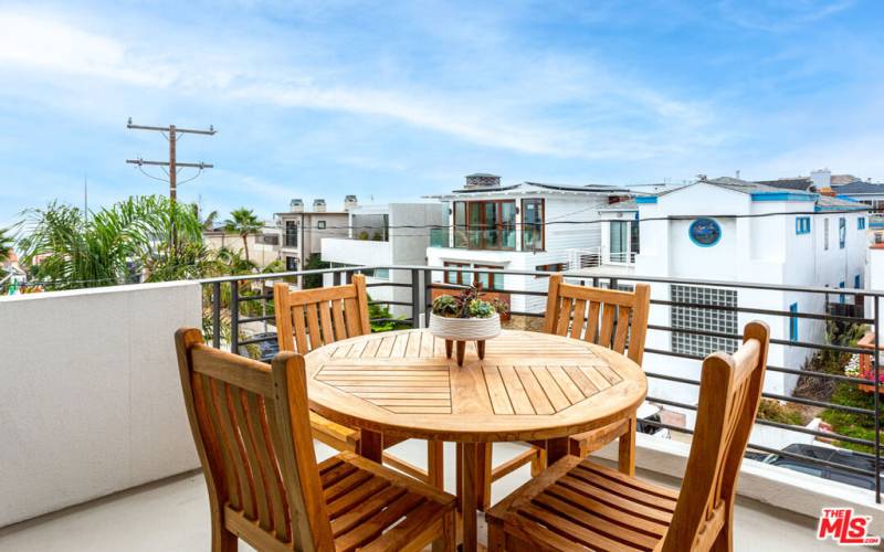 Outdoor dining table on living room balcony