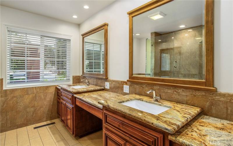 Hallway bathroom features custom countertops and fixtures with tub/shower combo.