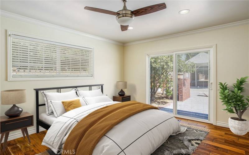 Virtually staged Primary bedroom .  Sliding door  to the back patio & pool.