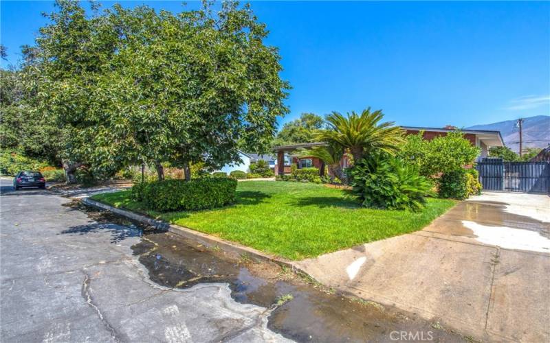 Side view shows additional parking driveway on the east side of the home.