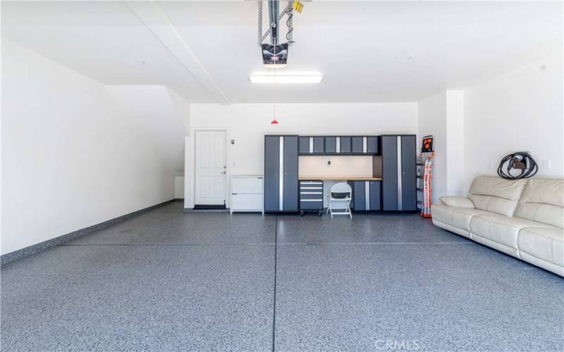 Two car garage with commercial grade epoxy floor, metal cabinets