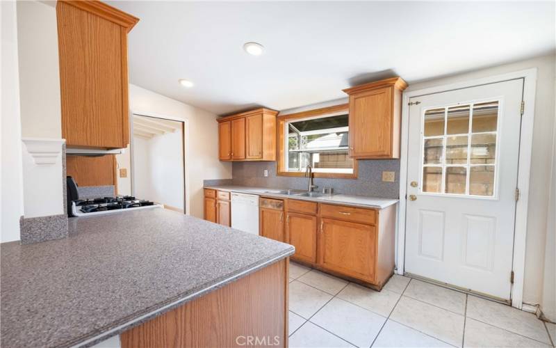 Kitchen with a garden window, stainless steel sink & side door to the side yard area