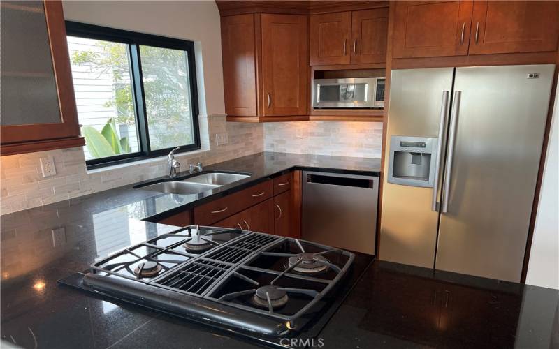 Custom wood cabinets and beautiful polished stone counter tops.