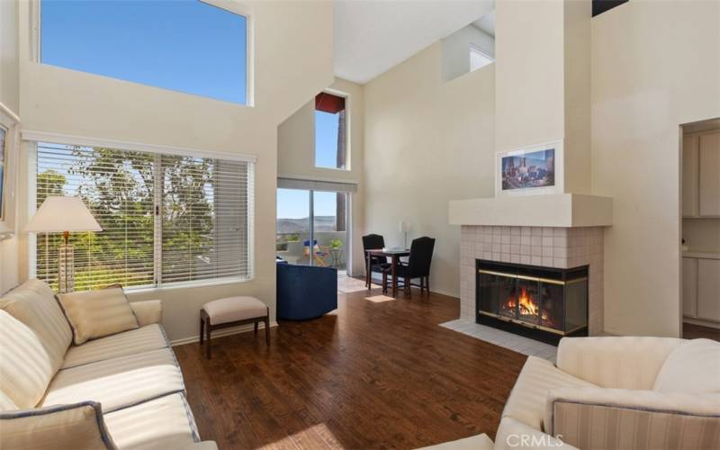 living room with high windows and alcove area