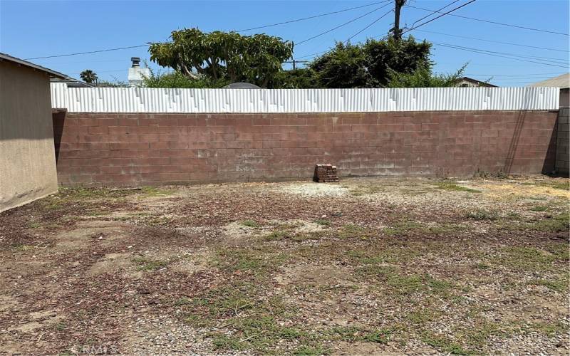 view of backyard behind detached garage looking east.