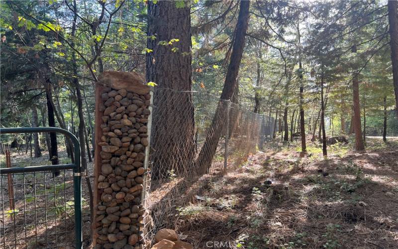 Main gate post and fence along Headwaters Rd.