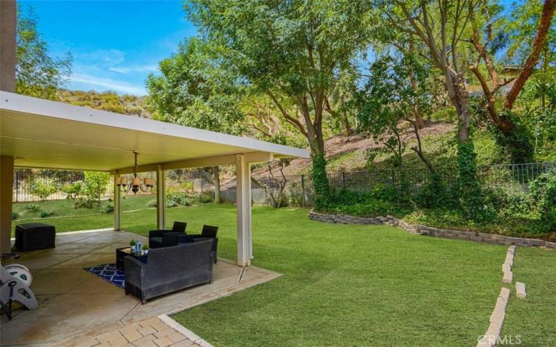 Private yare with expansive patio cover. Grass in forefront has been touched up in photo