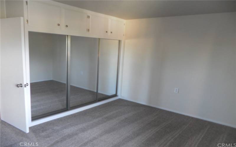 bedroom closet with mirror door