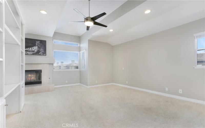 large primary suite with fireplace and private deck