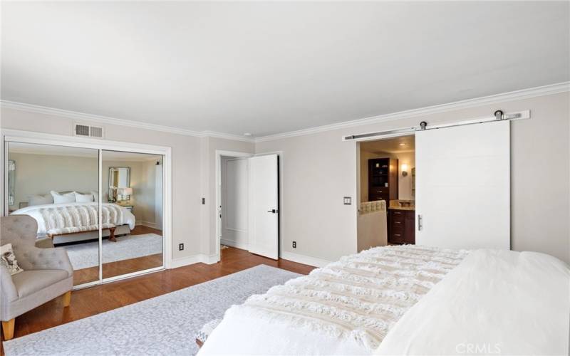 The master suite features two closets, including a spacious walk-in and a hidden storage closet