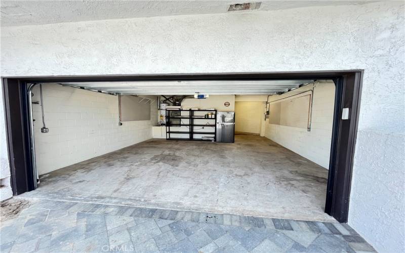 2+ Car garage with floor shelving storage as well as overhead storage.