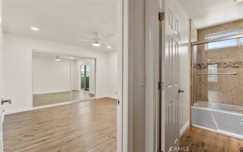 The adjoining bathroom features contemporary fixtures and a clean, fresh design.