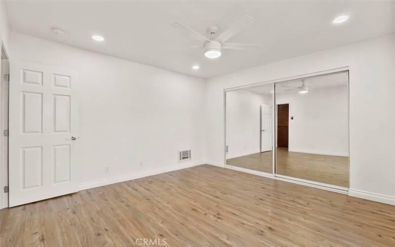 The primary bedroom is light, bright and airy.