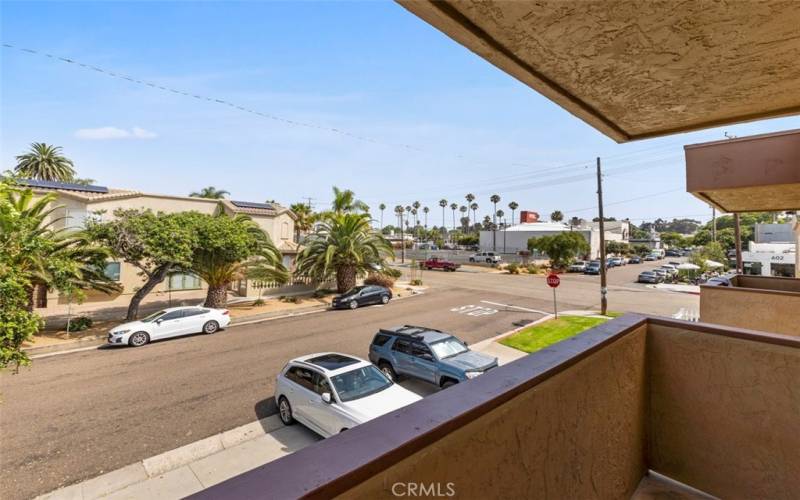 Open the sliding glass doors from the primary bedroom to the balcony to soak in the coastal breeze.