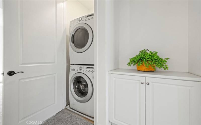 Upstairs laundry next to lined storage