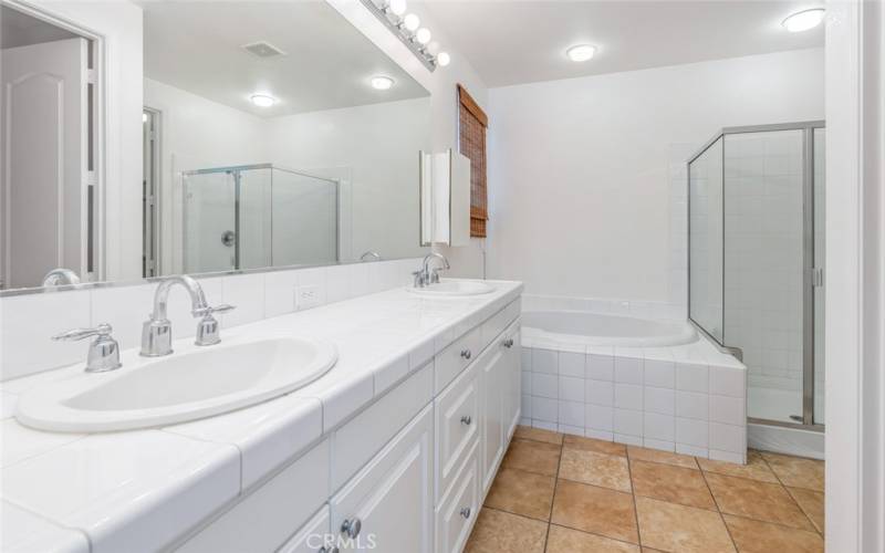 The primary bathroom is a retreat with dual sinks and a separate tub and shower.