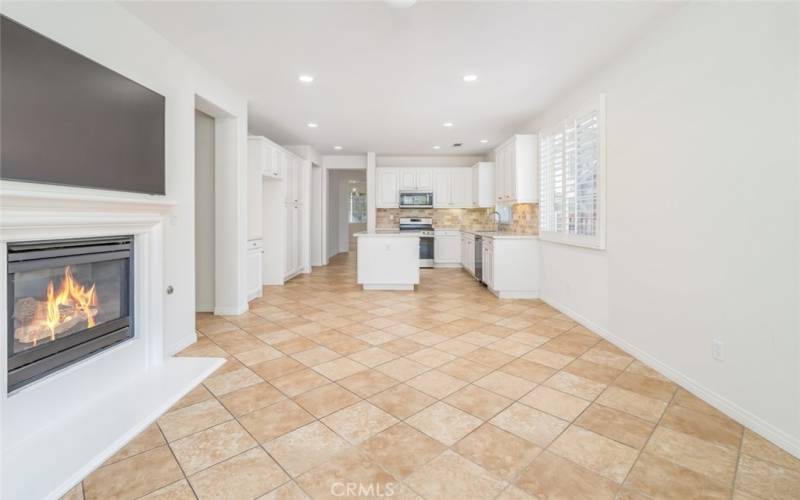 The kitchen seamlessly connects to the large family room that has a cozy fireplace.