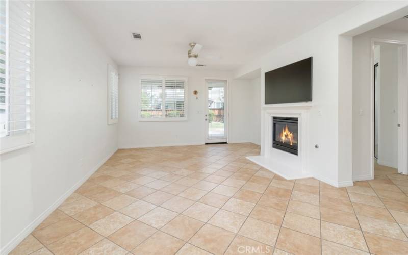 The family room offers windows with shutters that provide natural lighting.