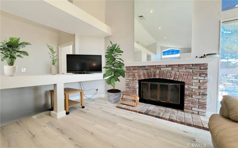 Cozy brick fireplace. Virtually staged.