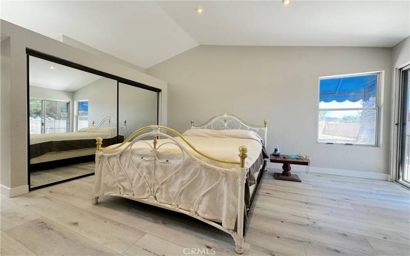 Primary bedroom with mirrored wardrobe doors