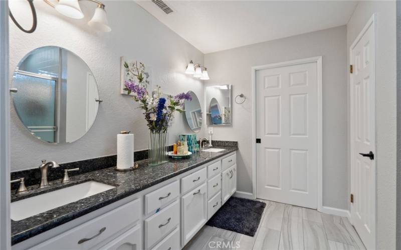 Private Primary Bath on the Second Floor upgraded with dual wash basins and newer cabinets.  The Primary Suite also features a large walk-in closet