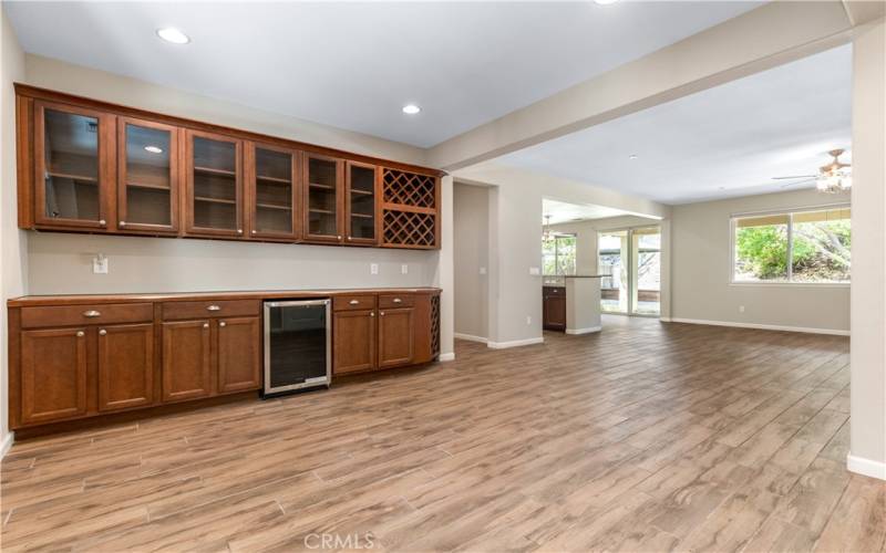 Expansive Dining area with full wall dry bar cabinetry and wine fridge