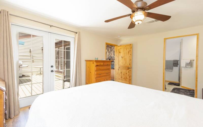 French doors open the primary bedroom to the rear deck. The primary bedroom is adjacent to the living room.