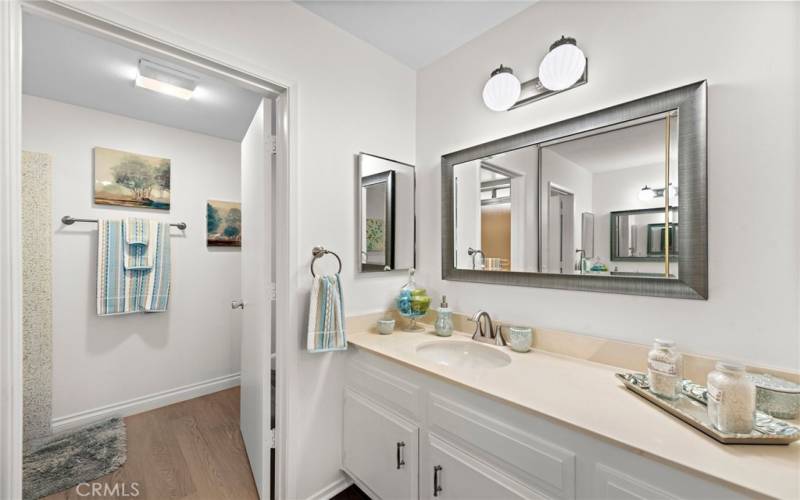 Master bath with designer mirror and entrance 

to bathroom with shower/tub combo.