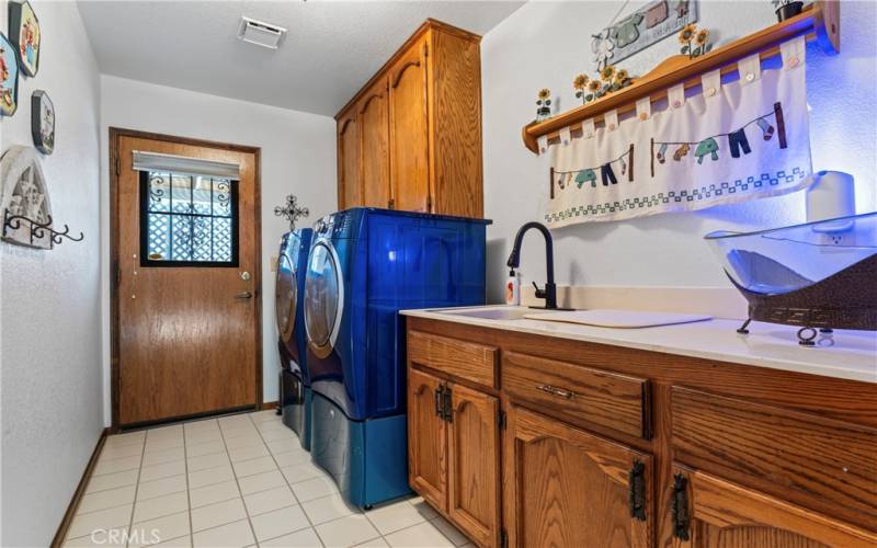 Large Oversized Laundry Room with Sink, Folding Counter, Plenty of Storage, Door Leads Out to RV Parking