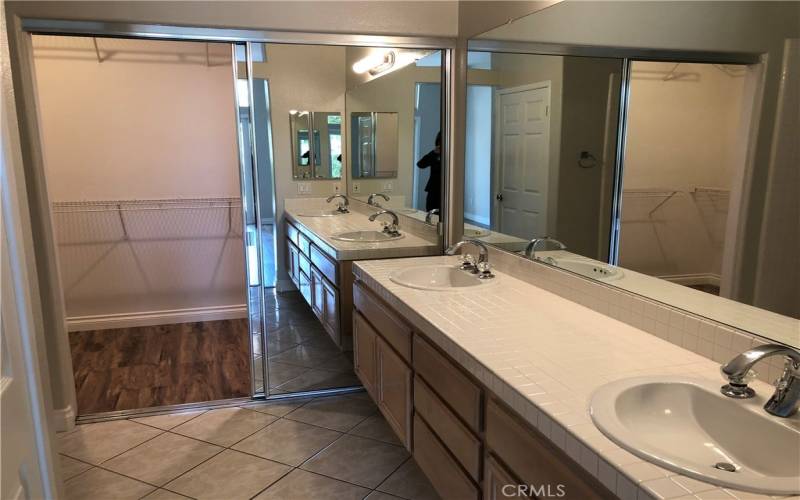 Master bath has dual vanity sinks and generous walk-in closet