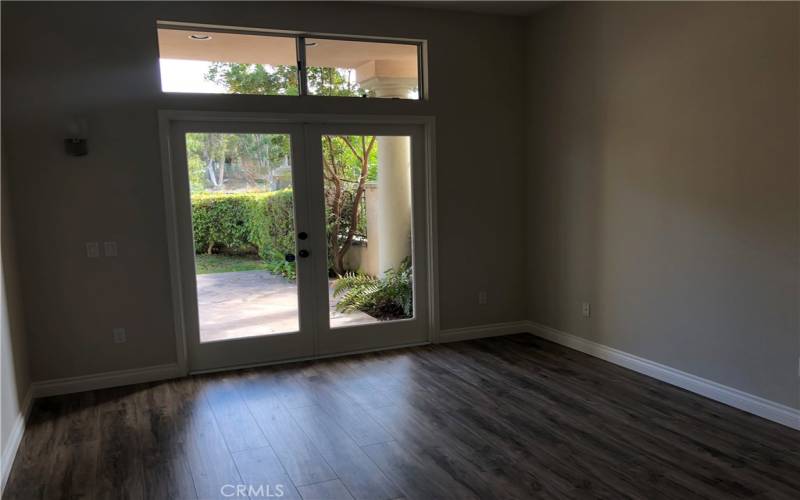 Master bedroom with vaulted ceilings opens to the private backyard through French doors.