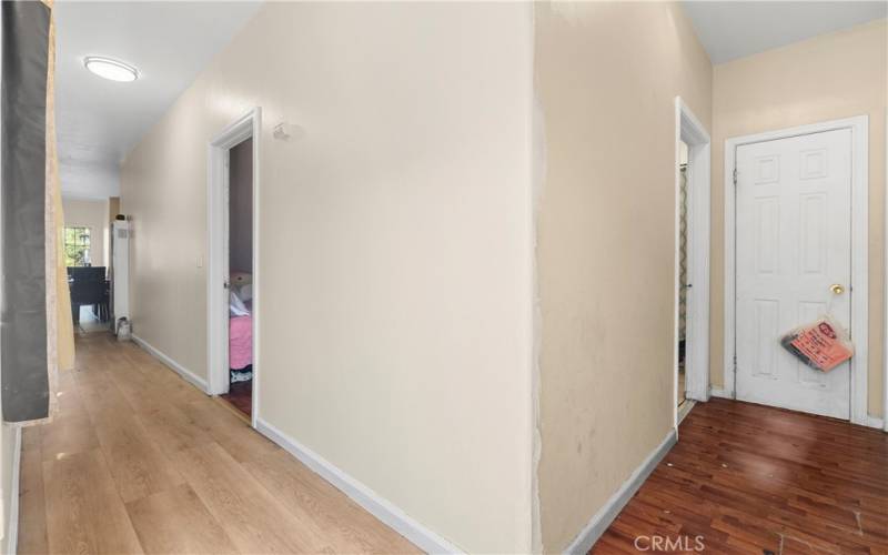  Lower Back Hallway Corner. Stack Laundry Closet behind Closed door on the Right. Bathroom is to the Left of that. There is a Side Door to the Back Yard in Back of this View