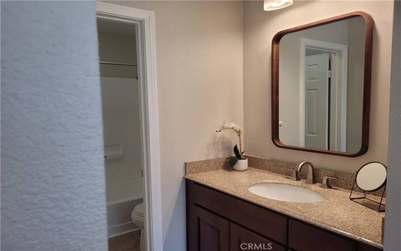 Primary bathroom vanity area with new mirror and vanity