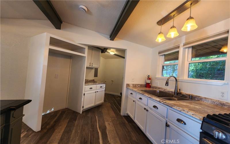 Kitchen view .. refrigerator opening and laundry