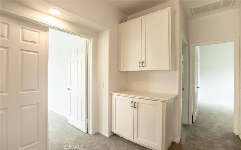 Storage cabinet immediately outside of primary bedroom