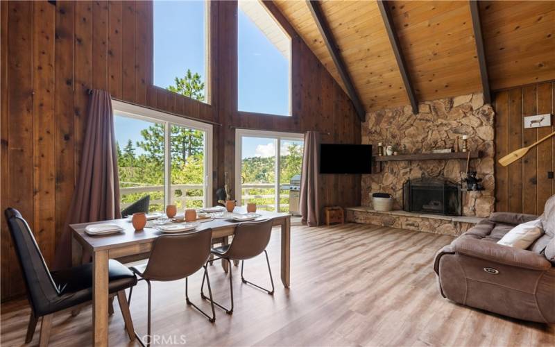 STONE FIREPLACE, 2 DOUBLE DOORS LEADING OUT TO BALCONY WITH PANORAMIC MOUNTAIN VIEW.