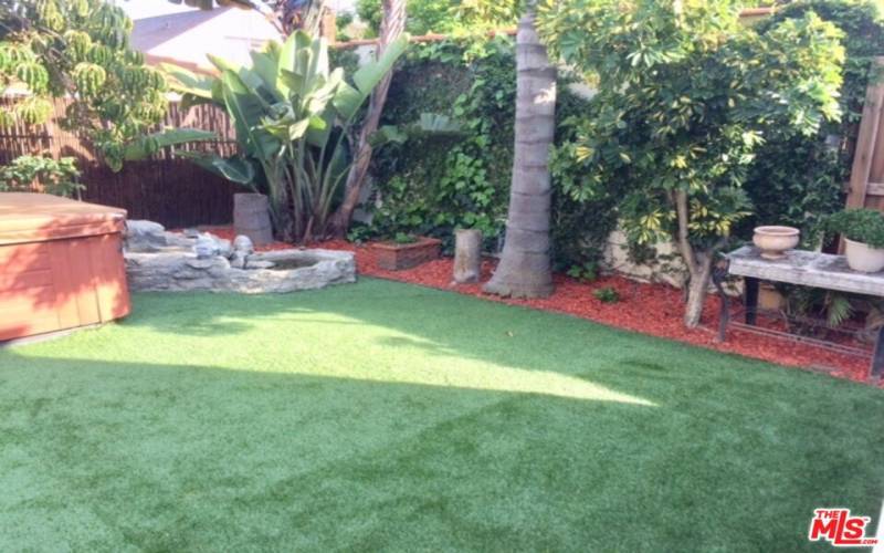 back yard with hot tub and water feature