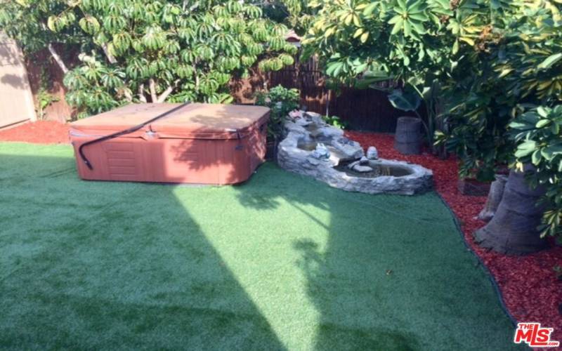 Water feature and hot tub in back yard