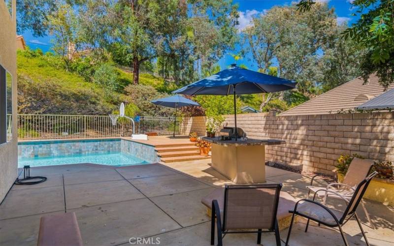 Built-In outdoor BBQ station with Bar seating possible and raised brick Fire pit