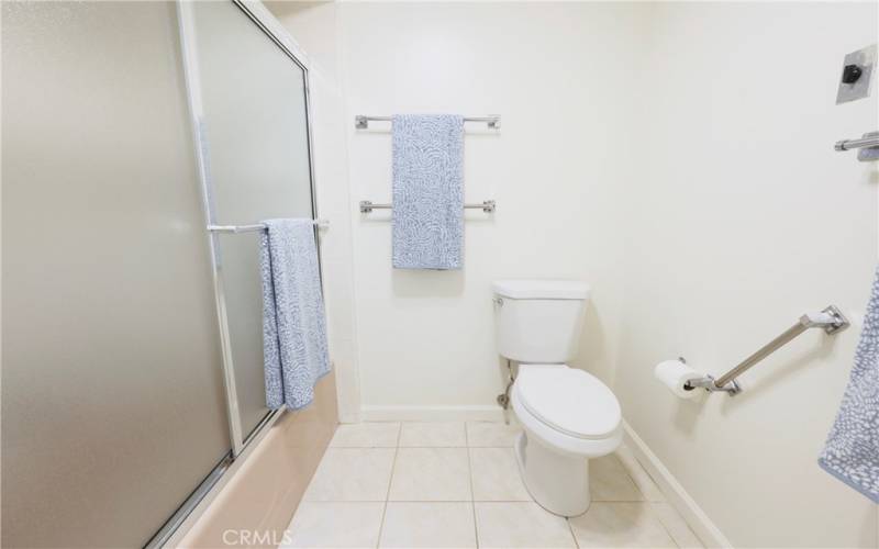 Tub with shower, sliding glass doors and grab bars